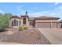 Stunning home exterior featuring a three-car garage and beautiful desert landscaping at 3060 N Ridgecrest -- # 200, Mesa, AZ 85207