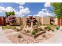 Beautiful condo complex featuring lush green landscaping and an inviting gazebo area at 1340 N Recker Rd # 109, Mesa, AZ 85205