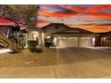 Beautiful single-story home featuring a three-car garage and desert landscaping, showcasing its charming curb appeal at 1502 W Wagner Dr, Gilbert, AZ 85233