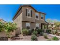 Charming townhome showcasing a well-maintained front yard with desert landscaping and a covered porch at 2640 N Heritage St, Buckeye, AZ 85396