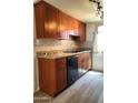 Well-lit kitchen features stone countertops and stainless steel dishwasher at 600 S Dobson Rd # 67, Mesa, AZ 85202