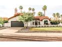 Charming home with a tile roof, manicured lawn, and desert landscaping at 10266 E Caron St, Scottsdale, AZ 85258