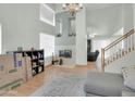 Spacious living area with fireplace, stairs, light-colored floors, chandelier and view to dining area at 1949 E Aire Libre Ave, Phoenix, AZ 85022