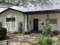 Charming front entrance with tiled walkway, decorative door, and inviting curb appeal with flowering plants at 6726 N 11Th St, Phoenix, AZ 85014