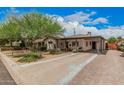 Inviting home showcasing a covered carport, lush greenery, and a well-maintained front yard at 6726 N 11Th St, Phoenix, AZ 85014