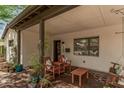 Cozy front porch area featuring comfortable seating, decorative plants, and unique architectural details at 6726 N 11Th St, Phoenix, AZ 85014