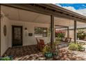 Charming front porch with comfortable seating, inviting decor, and views of the lush surroundings at 6726 N 11Th St, Phoenix, AZ 85014