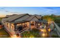 Stunning aerial view of backyard with outdoor living areas, fire pit, and mountain views at 6887 E Hacienda La Colorada Dr, Gold Canyon, AZ 85118