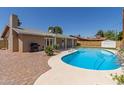 Inviting backyard pool with a lush brick patio and ample space for outdoor entertaining at 8129 N 17Th Dr, Phoenix, AZ 85021