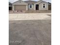 Charming single-story home with desert landscaping, a two-car garage, and a welcoming entrance at 14742 W Lariat Trl, Surprise, AZ 85387