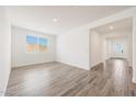 Bright living room showcasing modern finishes, wood tile flooring and natural light at 14742 W Lariat Trl, Surprise, AZ 85387