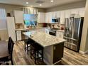 Spacious eat-in kitchen features stainless steel appliances, granite counters, and an island with seating at 3021 W Trapanotto Rd, Phoenix, AZ 85086