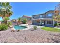 Backyard featuring a refreshing pool, palm trees, and ample space for outdoor enjoyment at 44254 W Adobe Cir, Maricopa, AZ 85139