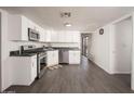 Modern kitchen with white cabinets, stainless steel appliances, gray flooring and granite countertops at 1108 N Esther St, Tempe, AZ 85288