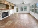 Spacious living room featuring tile floors and ample natural light from large windows at 12644 N 152Nd Ave, Surprise, AZ 85379