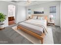 Serene bedroom with a neutral palette, carpet, ceiling fan, and an ensuite bathroom at 12644 N 152Nd Ave, Surprise, AZ 85379