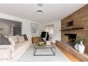 Cozy living room featuring a stone fireplace and natural light at 1316 E Vermont Ave, Phoenix, AZ 85014