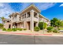 Charming two-story townhome with manicured landscaping, stucco, and a glimpse of private balconies in a well-maintained neighborhood at 15221 N Clubgate Dr # 2132, Scottsdale, AZ 85254