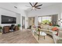 Bright living room featuring a ceiling fan, large window, and a comfortable seating arrangement at 15550 S 5Th Ave # 140, Phoenix, AZ 85045