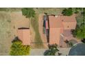 An aerial perspective highlights the property's terracotta roofing and layout, accented by lush green trees at 1637 S Los Alamos Cir, Mesa, AZ 85204
