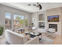 Cozy living room with fireplace, mounted TV, comfortable seating and bright natural light at 16600 N Thompson Peak Pkwy # 2050, Scottsdale, AZ 85260