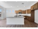 Modern kitchen featuring a large island, stainless appliances, and a beautiful backsplash at 18150 W Tanglewood Dr, Goodyear, AZ 85338