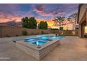 Luxurious backyard featuring a pool, spa, and ample patio space, perfect for outdoor gatherings at 22296 E Maya Rd, Queen Creek, AZ 85142