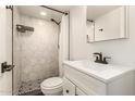 Bathroom featuring modern fixtures, a shower with marble hexagon tiles, and stylish black and white floor at 2236 W Shaw Butte Dr, Phoenix, AZ 85029