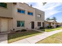 Exterior view of townhome with a well-manicured lawn and sidewalk at 225 N Standage -- # 30, Mesa, AZ 85201
