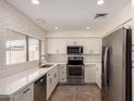 Updated kitchen with stainless steel appliances, white cabinets, and a tiled floor, creating a clean, modern look at 234 S Neely St, Gilbert, AZ 85233