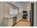 Modern kitchen features stainless steel appliances, white subway tile backsplash, and ample countertop space at 234 S Neely St, Gilbert, AZ 85233