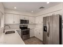 Stylish kitchen featuring stainless steel appliances, white cabinetry, and ample counter space, perfect for cooking at 234 S Neely St, Gilbert, AZ 85233
