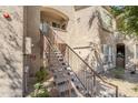 Condominium complex with stair access, showcasing an outdoor fire riser room and tidy desert landscaping at 29606 N Tatum Blvd # 265, Cave Creek, AZ 85331