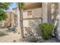 A view of a condo with well-maintained exterior, desert landscaping and greenery surrounding at 29606 N Tatum Blvd # 265, Cave Creek, AZ 85331