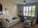 Cozy living room with plantation shutters, comfortable seating, and a ceiling fan at 29606 N Tatum Blvd # 276, Cave Creek, AZ 85331