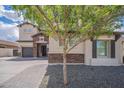 Charming home exterior with stone accents and a welcoming tree-lined front yard at 2969 E Trigger Way, Gilbert, AZ 85297