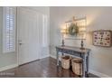 Inviting home foyer with decorative table, baskets, and a view of the front door at 2969 E Trigger Way, Gilbert, AZ 85297