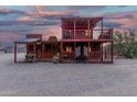 Unique Western-style home with a wooden facade, balcony, and rustic details, evoking a charming old-west feel at 29972 N Bryce Trl, San Tan Valley, AZ 85144