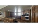 Spacious kitchen with tiled countertops and cooktop island, awaiting modernization at 4242 W Sandra Ter, Phoenix, AZ 85053
