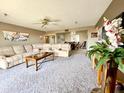 Spacious living room featuring cozy seating, a ceiling fan, and artwork at 425 S Parkcrest -- # 335, Mesa, AZ 85206