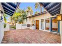 Inviting outdoor patio with a brick surface and built-in grill, providing a cozy space for outdoor cooking and dining at 4420 N 47Th Pl, Phoenix, AZ 85018