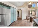 Charming kitchen with blue cabinets, stainless steel appliances, and breakfast nook with terra cotta tile at 5 W Ranch Rd, Tempe, AZ 85284