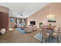 Bright living room with vaulted ceiling and dining area with stylish chandelier and comfortable seating at 5 W Ranch Rd, Tempe, AZ 85284