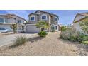 Two-story home boasts desert landscaping, neutral stucco, and a large two-car garage at 515 S Apache Dr, Chandler, AZ 85224