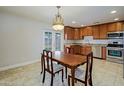 Cozy dining area with kitchen view, complete with stylish lighting at 6120 W Keim Dr, Glendale, AZ 85301