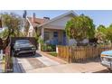 Inviting home exterior with a quaint front porch, fenced yard, and private driveway at 711 E Mckinley St, Phoenix, AZ 85006