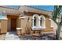 Charming home with a distinctive stucco exterior, terracotta roof, and arched window detail at 7730 E Boise St, Mesa, AZ 85207