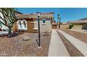 Charming single-Gathering home with well maintained desert landscaping and a private driveway at 7730 E Boise St, Mesa, AZ 85207
