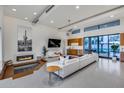 Bright and airy living room with a modern fireplace, pit seating, and access to the outdoor pool area at 12809 N 67Th St, Scottsdale, AZ 85254
