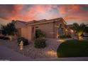 Attractive home exterior with desert landscaping, stone accents, and a tile roof at 15664 W Vernon Ave, Goodyear, AZ 85395